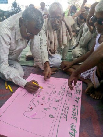 Community health workers in Uttar Pradesh, India map out their strategy to visit each household in each cluster. 