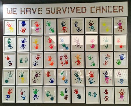 Wall of children's hand prints who were given life-saving eye cancer treatment by Operation Eyesight