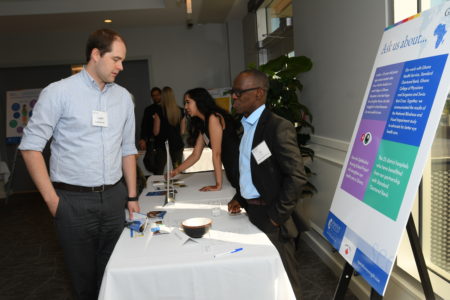 Bo Wiafe speaking qwith a visitor to his booth.