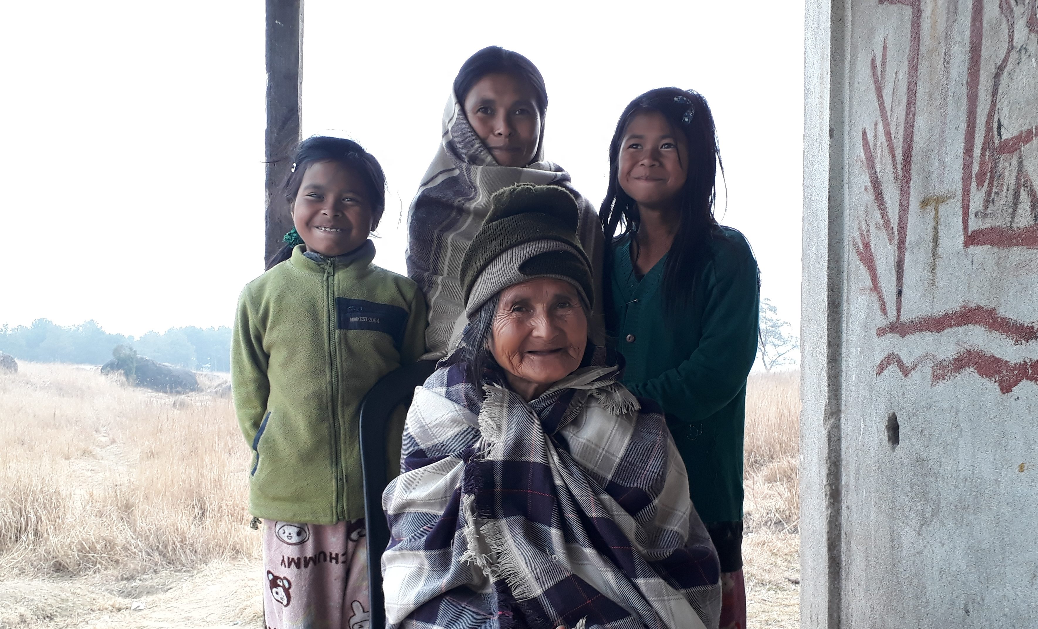 Senior woman posing with three children.