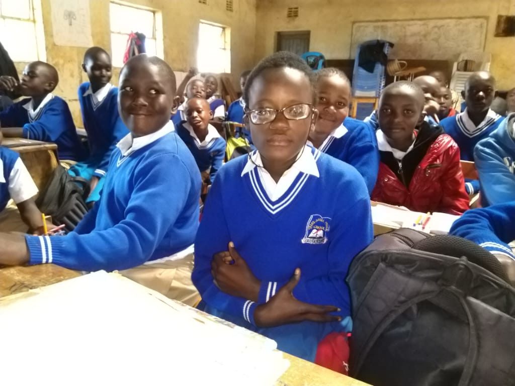 Hellen in her classroom with other students