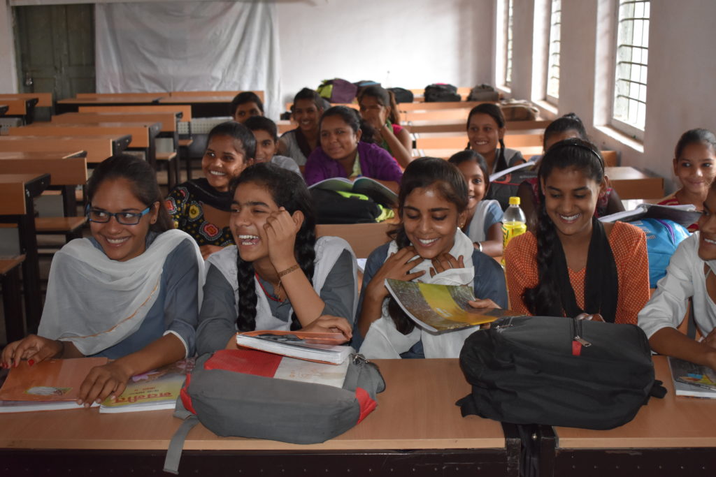 Tina sits with her classmates in her classroom