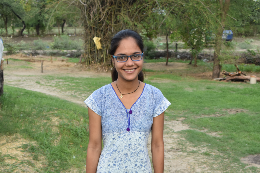 Tina wearing her eyeglasses, looking at the camera