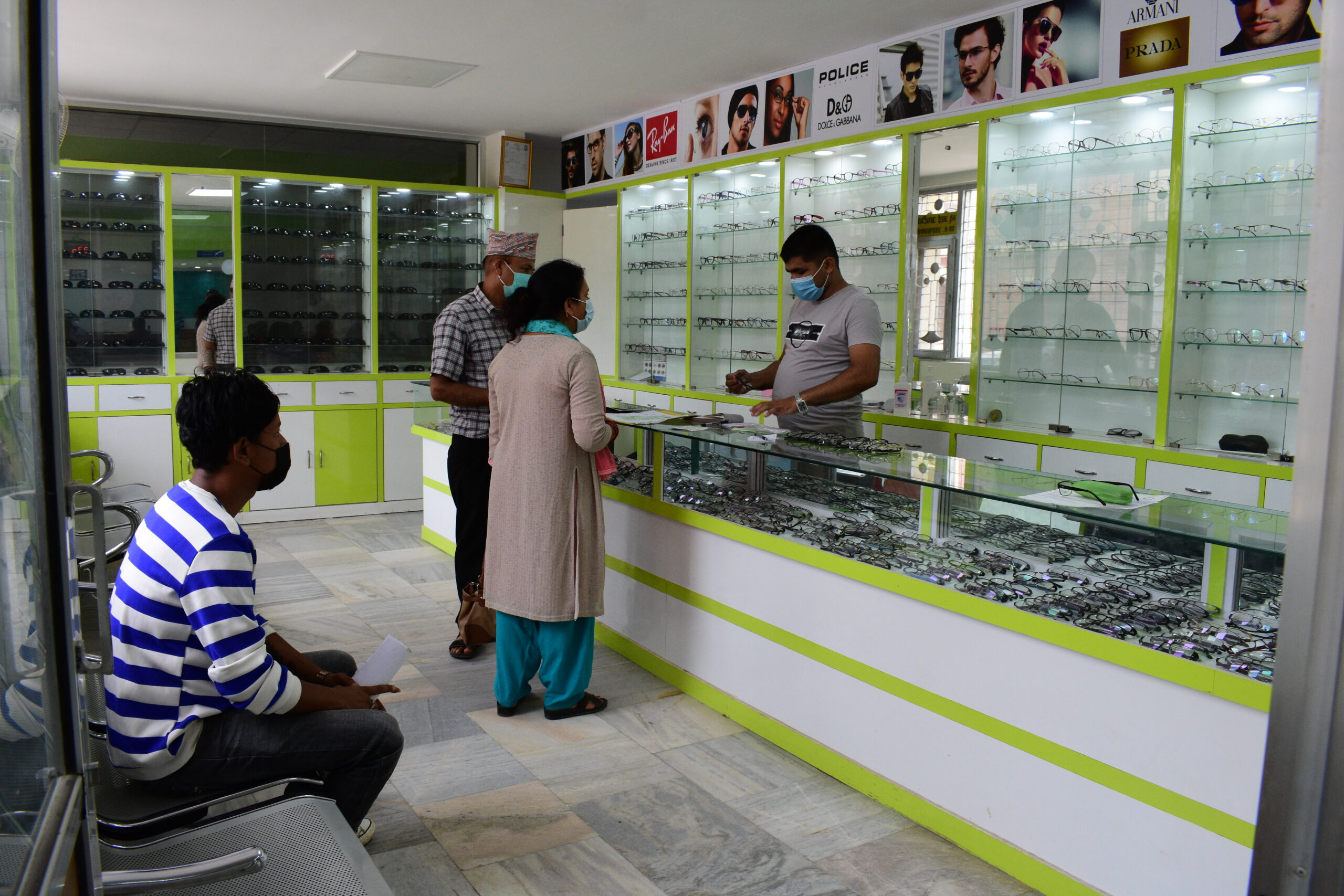 A couple purchasing glasses at an optical shop.