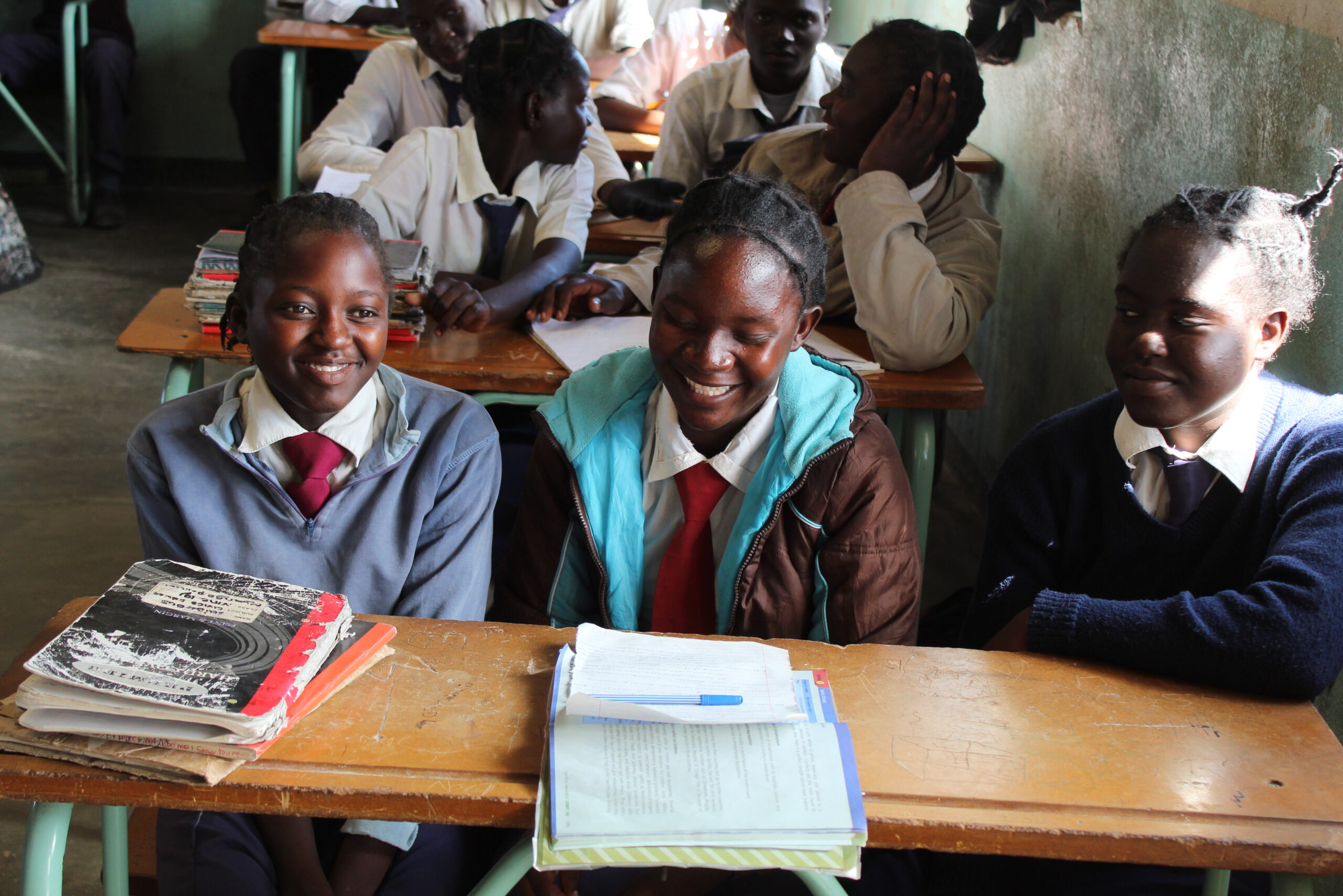 Group of young girls smiling at school in Zambia.