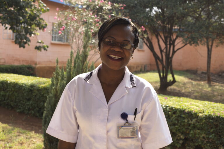 A healthcare professional, smiling at the camera