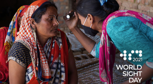 A young woman looking into the eyes of a senior woman using a flash light. The logo on the image reads 2021 World Sight Day