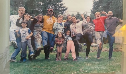Photo of a group of people, merrily posing for the camera