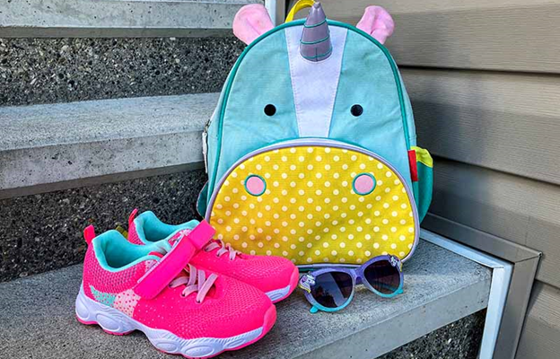 Photo shows a schoolbag, pair of shoes and a pair of sunglasses