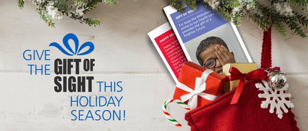 An image of Christmas gifts and gift tags with the text "Give the Gift of Sight This Holiday Season"