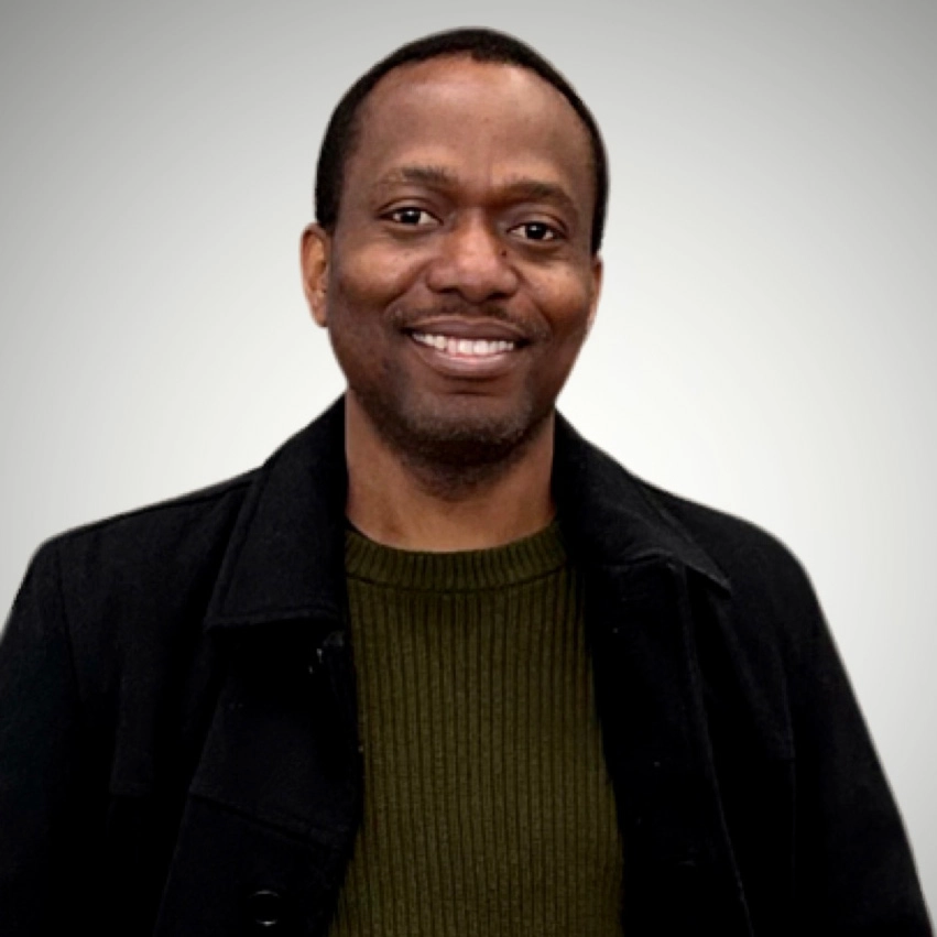 Man smiles at camera.