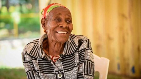 A female senior smiles.