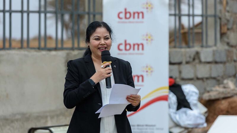 A woman speaking into a microphone.