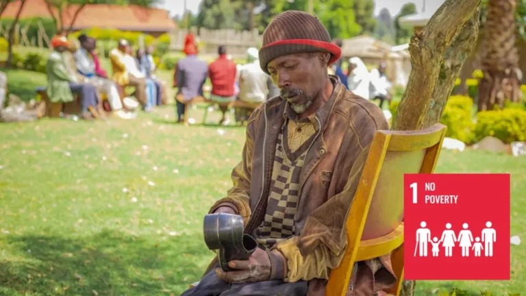 A man sits outside on a chair working on a leather shoe.